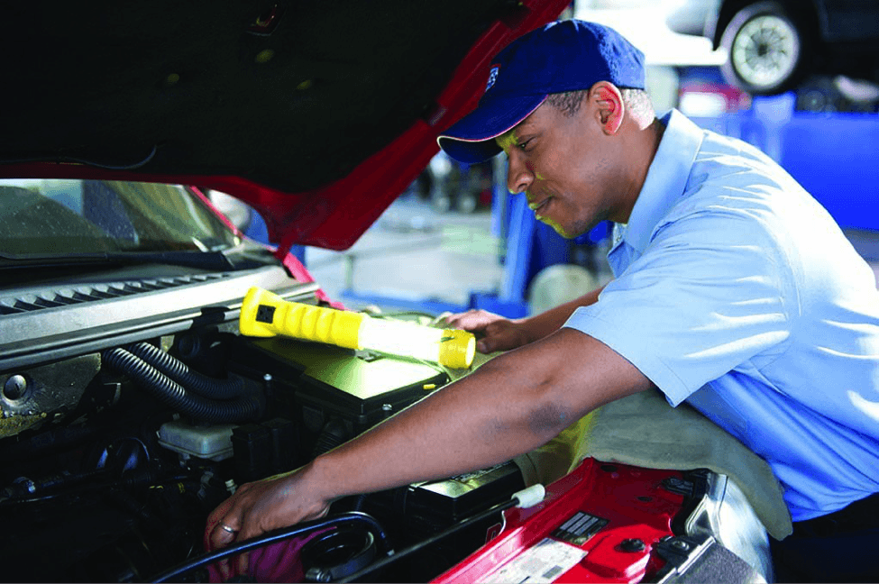 Aamco franchise worker fixing the transmission on a car