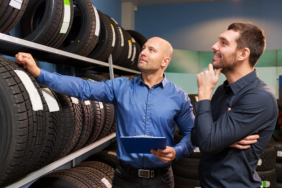tire franchise owner selling tires to customer